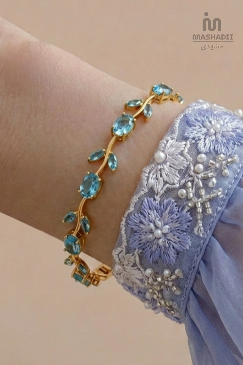 Aqua Blue Tulip Bracelet crafted from premium stainless steel with sparkling aqua blue crystal accents and an elegant tulip flower design. Waterproof, tarnish free bracelet for women with long-lasting shine and durability.