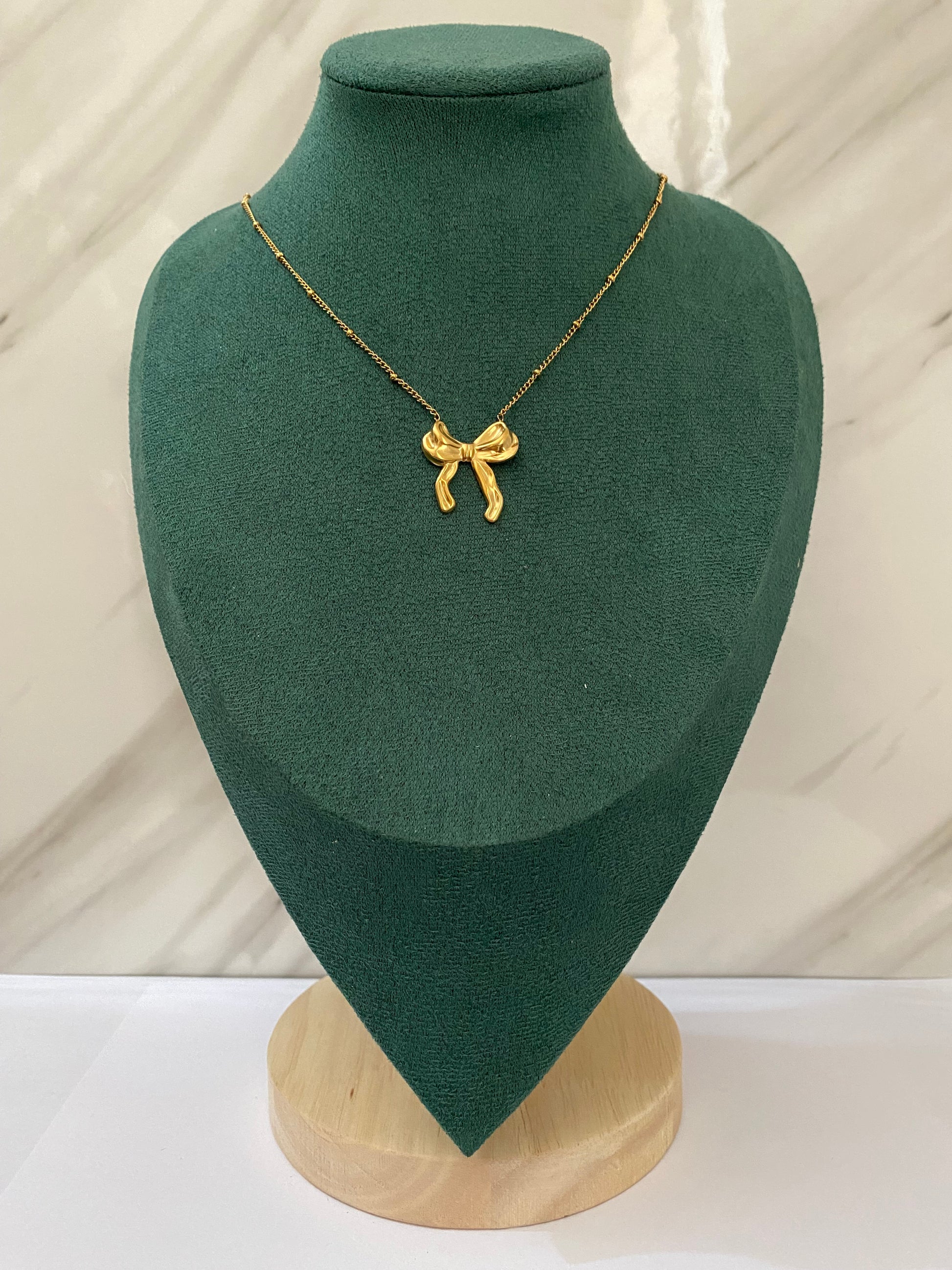 Gold Bow with Beaded Chain Necklace featuring an elegant bow pendant paired with a delicate beaded chain, crafted from premium stainless steel. Waterproof, tarnish-free jewelry for women, perfect for everyday wear, parties, weddings, gifting, office wear, and stylish fashion looks.
