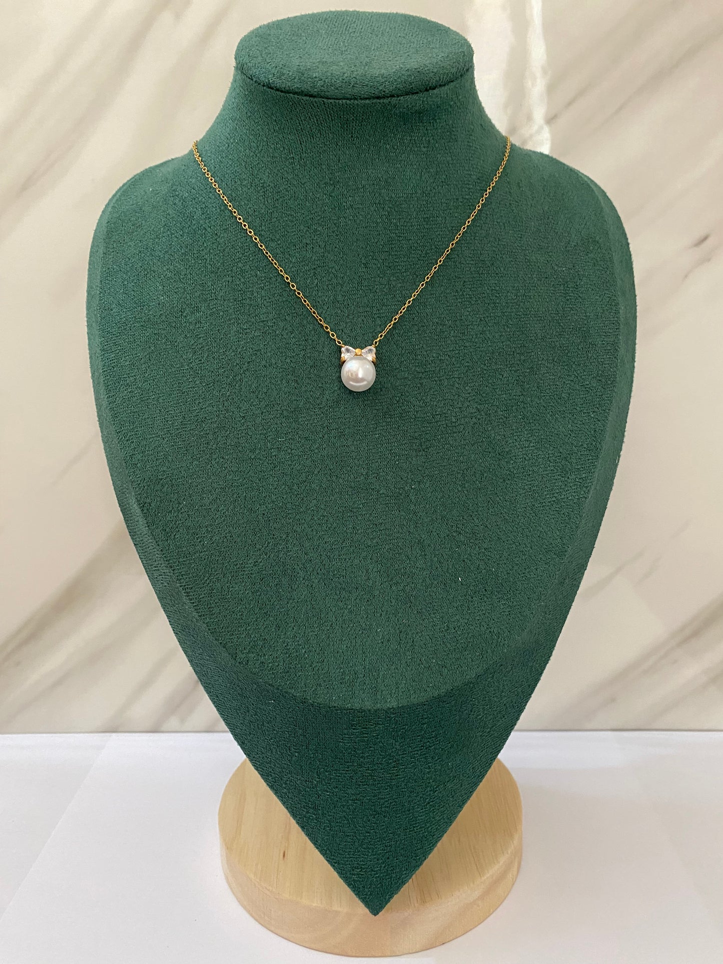Gold Pearl Bow Necklace featuring a graceful bow-shaped pendant with elegant pearl detailing, crafted from premium stainless steel. Waterproof, tarnish-free jewelry for women, ideal for daily wear, weddings, parties, gifting, anniversaries, and sophisticated styling.
